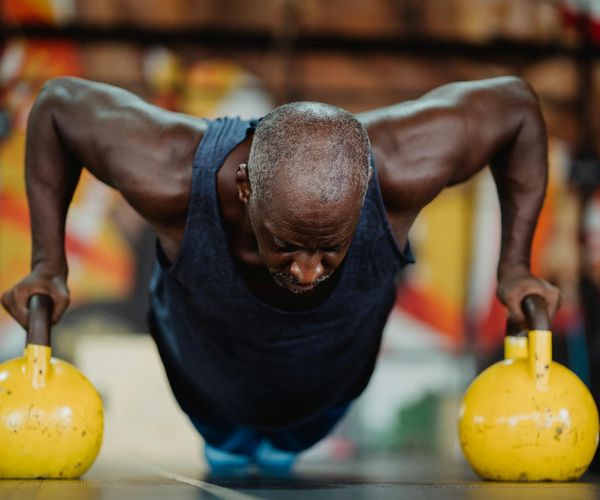 Man holding a kettlebell with focus and determination.